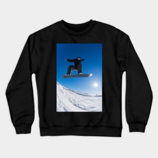 Snowboarder jumping against blue sky Crewneck Sweatshirt